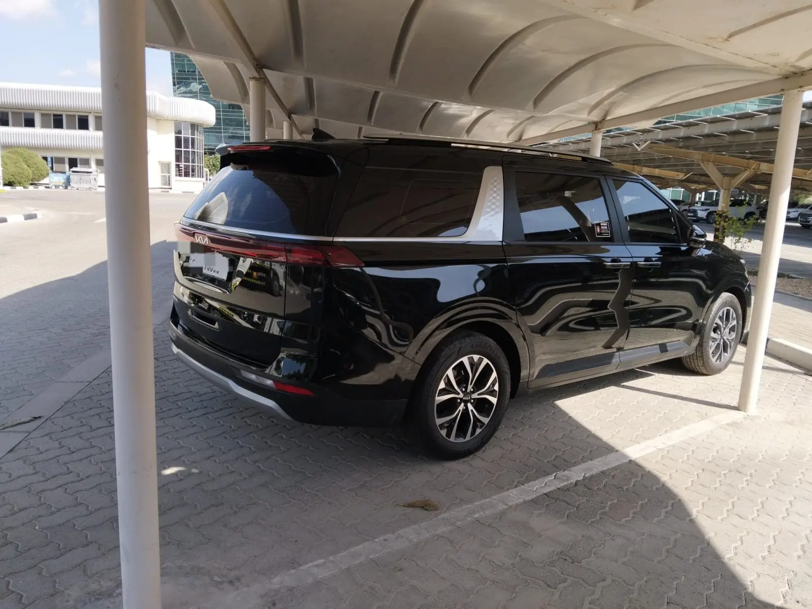 Black Kia Carnival 7-seater used for Abu Dhabi city tours