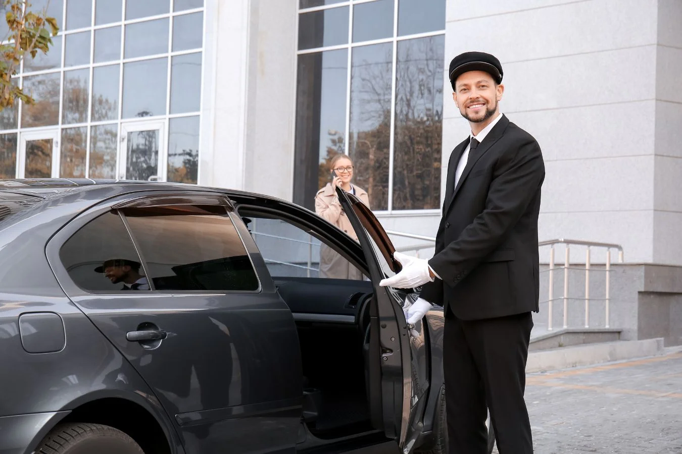 Uniformed Carpools UAE driver welcoming a passenger